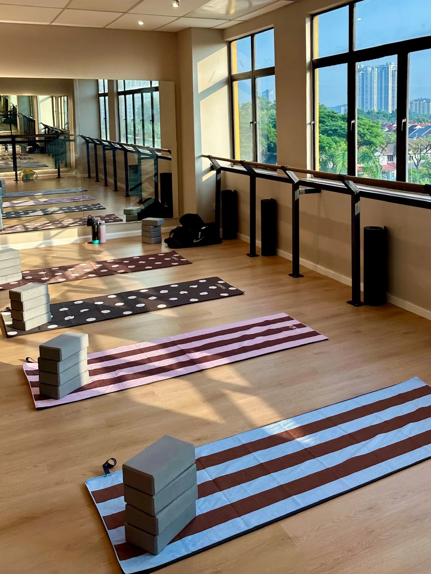 Tualarr towels laid out on the floor of a bright Pilates studio